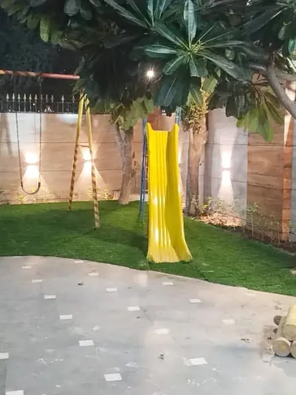 This artificial grass installation in a residential society in Kaushambi created a clean and safe play area for kids with swings and a slide.