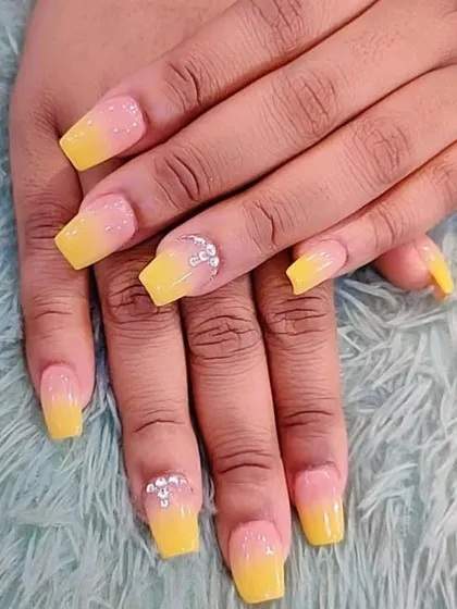 A sunny yellow and pink ombre design on square nails with a touch of crystal sparkle.