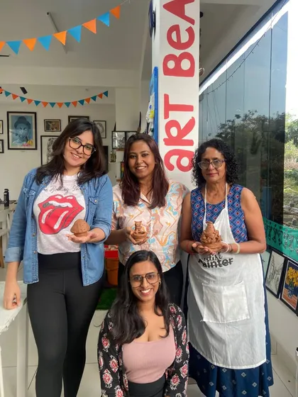 A group of friends proudly shows off the Ganesha idols they made in a special festive workshop.