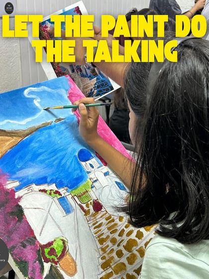 Let the paint do the talking. This young artist is completely absorbed in her large canvas painting, carefully adding details to a beautiful landscape.