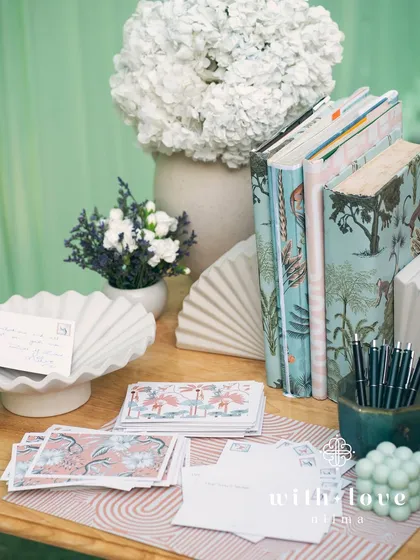 The guest message station at the baby shower, with elegant stationery and floral details.