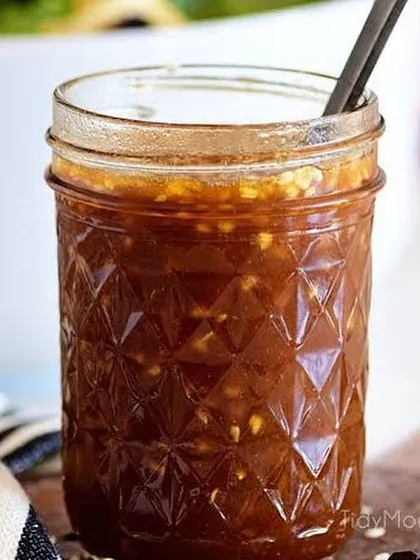 A jar of my Asian Honey Sesame dressing. The texture from the sesame seeds and minced ginger is visible, promising a punch of flavour.