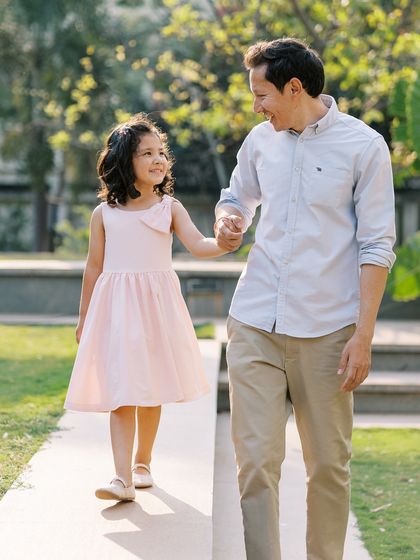 A father and daughter walking hand-in-hand. A sweet and timeless moment of connection.