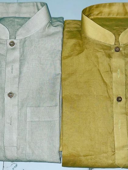 Two freshly stitched cotton kurtas in light grey and mustard yellow. I focus on neat stitching and quality fabric for even the simplest garments.