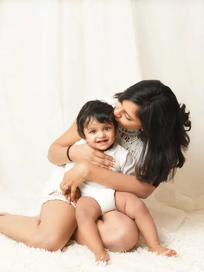 A mother gives her giggling son a big hug. These photos are all about capturing the real, everyday love and affection within a family.