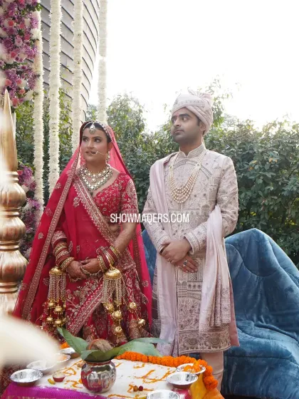 Priyanka and Ashish during their daytime wedding rituals. The mandap is adorned with cascading white florals, creating a serene and beautiful atmosphere for the sacred ceremony.