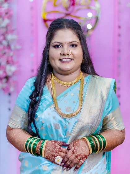 A duplicate of image 7, this close-up captures the client's radiant smile and the flawless finish of her makeup, perfect for her engagement day photos.