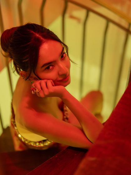 An artistic shot of Anushka Sen during the Cannes after-party, with warm, dramatic lighting.