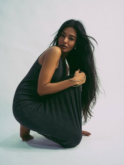 A variation of the crouching pose, showing a different angle and expression.