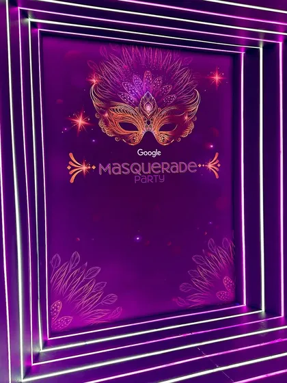 A clear shot of the custom-designed backdrop for the Google Masquerade Party. This shows how we can incorporate event-specific branding and themes into a sleek, modern video booth setup.