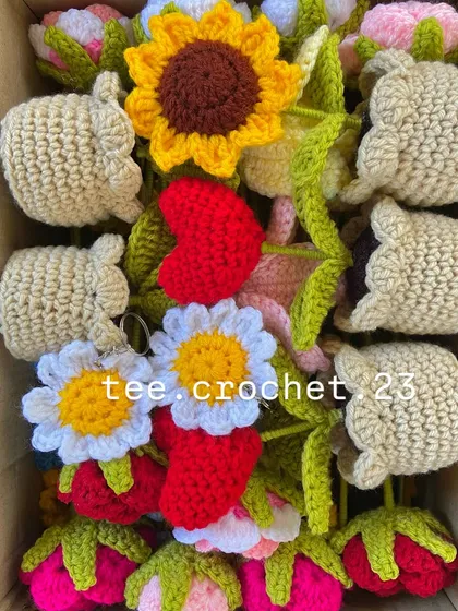 A box filled with a mix of custom keychains, including bunnies, hearts, daisies, and strawberries, carefully arranged for shipping.