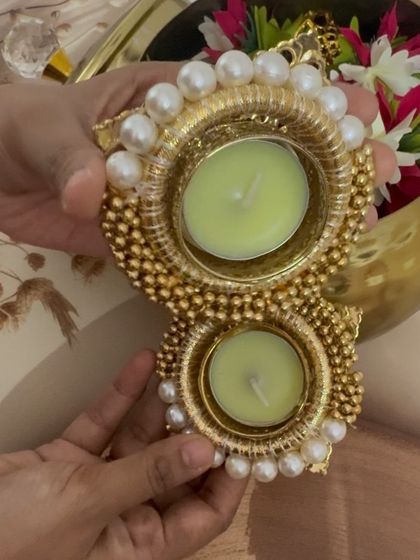 This is a close-up of the beautiful pearl and gold bead T-light holders included in my Diwali handi hamper. They are handcrafted and add a touch of opulence to your festive lighting.