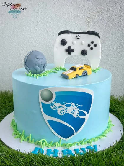 A gaming-themed cake for a young lad. This design features a handmade fondant joystick, a Hot Wheels car, and an edible print of the Rocket League logo.