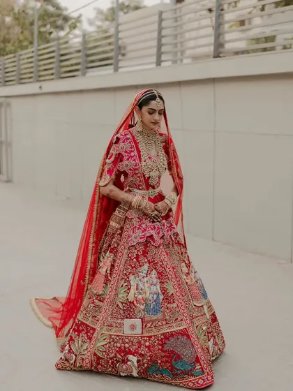 The bride walking alone, a moment of quiet reflection before her farewell. The simplicity of the setting contrasts with her ornate attire, creating a powerful image.