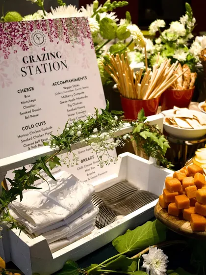 The details matter. A custom-printed menu for a grazing station clearly lists the curated selection of cheeses, cold cuts, and accompaniments like fig chutney and smoked honey, reflecting the thoughtful and bespoke nature of my service.