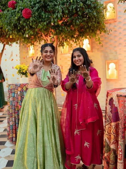 Guests proudly showing off their mehendi designs. It's a beautiful tradition that brings everyone together in celebration.