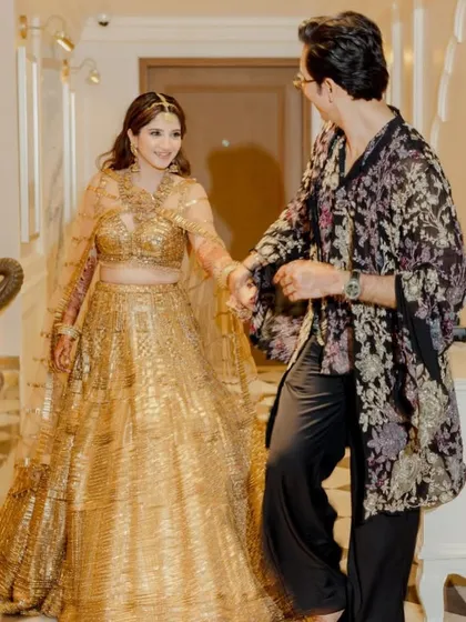 A stylish pre-performance shot of the couple, ready to take the stage.