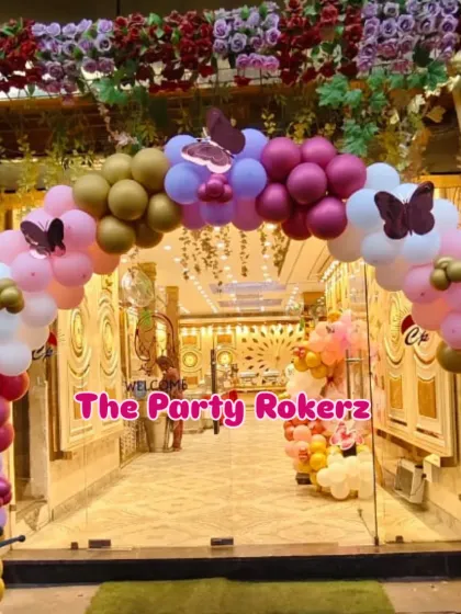 A grand entrance arch for a butterfly-themed party at a banquet hall. The arch is decorated with colorful balloons and butterfly cutouts, creating a stunning welcome for guests.