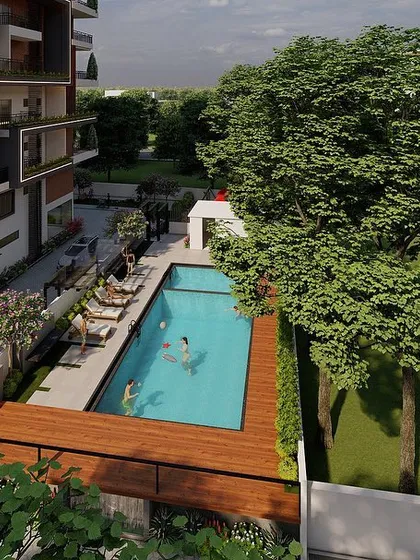 This high-angle shot focuses on the lifestyle aspect of a residential complex, showing the swimming pool and lounge area in detail. It helps potential residents envision themselves enjoying the amenities we can help design and visualize.