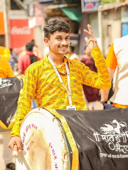 The color version of the smiling young dhol player.