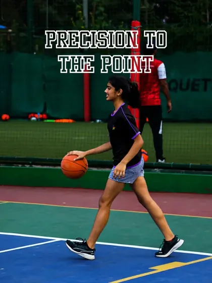 A player demonstrates precise dribbling technique. Mastering ball control is essential, and our court provides the ideal surface for practicing your handles.