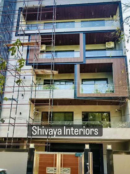 I handle large-scale, multi-story building elevation projects from start to finish. This image shows an in-progress site where my team is meticulously installing a combination of wood-look panels and other cladding materials to completely transform the exterior.