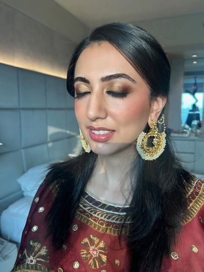 This image captures the rich, metallic tones of the eyeshadow with the client's eyes closed. It highlights the seamless blending and precision of our makeup application.