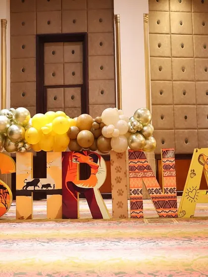 A close-up of the personalized "SHRINAY" letter blocks, each decorated with unique patterns and characters from The Lion King. This makes for a fantastic photo opportunity and centerpiece.