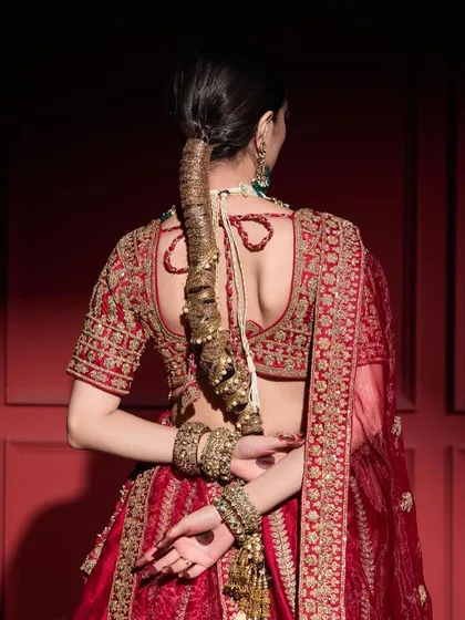 A traditional gota braid is a stunning choice for a bride. I wrapped the hair meticulously with golden gota patti and added ghungroo details, creating a rich, textured look that is deeply rooted in Indian wedding traditions and looks incredible with a bridal lehenga.