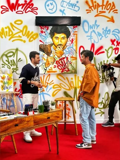A shot from the campaign set, discussing the artwork with Divyenndu. The entire set was designed with my graffiti to create a fully immersive, artistic environment.