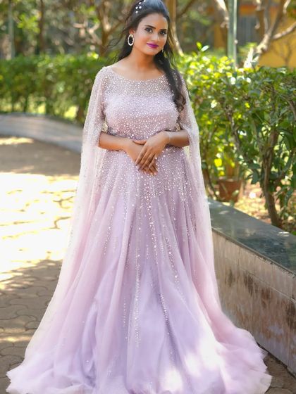 This lilac gown with pearl embellishments and cape-like sleeves is a dreamy choice for an engagement or reception.