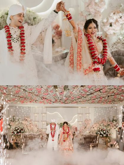 A collage of the couple's Varmala, set against a dreamy, cloud-like stage with sparklers, creating a fairytale atmosphere.