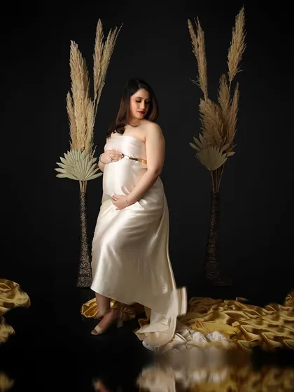 A quiet moment of anticipation. This portrait uses dramatic lighting and a simple setup with pampas grass to create a moody and artistic feel.