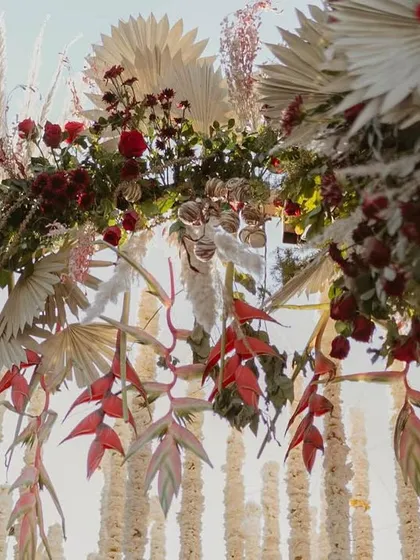 A closer look at the intricate floral work on our Sabyasachi-inspired 'Regal Rustic Reverie' mandap. We layered rich red florals with dried pampas grass and other rustic elements to create a design that is full of texture, depth, and romance.