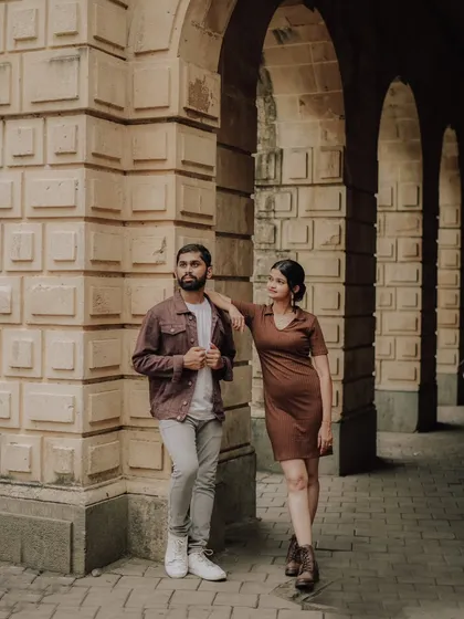 A cool, editorial-style pose against the textured walls of a heritage building in Mumbai. This shot showcases Pragati and Swapnil's modern style.
