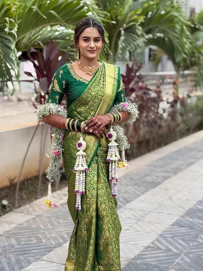 A full-length view of a bride wearing our fresh floral kaliras and armlets.