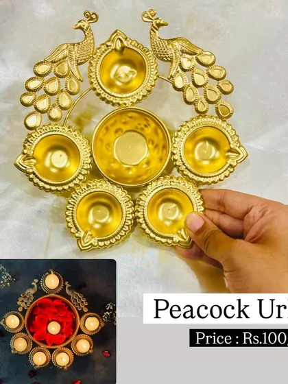 Our peacock urli is an elegant decorative bowl, perfect for holding water and floating flowers or diyas during festivals. The intricate peacock design and golden finish make it a standout piece.