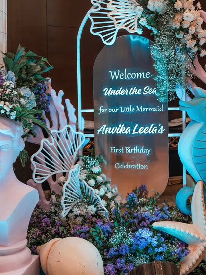 The welcome sign for our 'Little Mermaid', Anvika Leela. The sign is surrounded by custom props like a seahorse, starfish, and floral arrangements, setting a magical tone from the start.