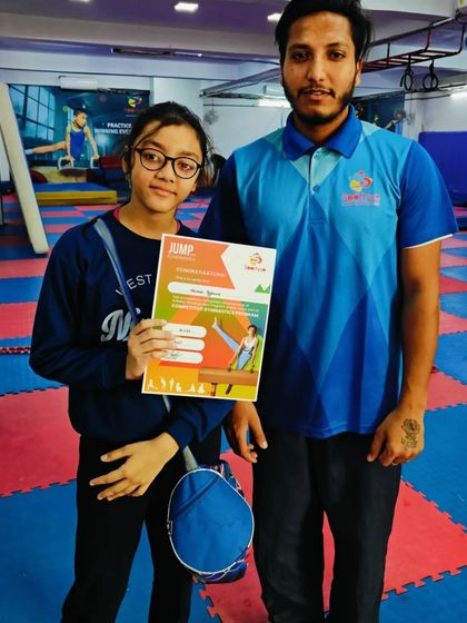 This student poses with her coach after receiving her certificate.