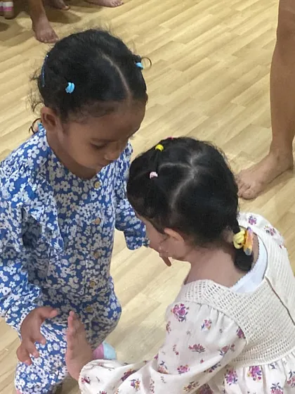 Two of our youngest students learning to support each other, both literally and figuratively. Teamwork and empathy are skills we start building from day one.