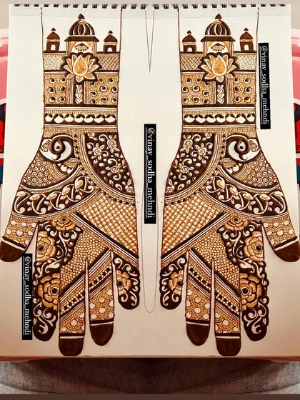 This symmetrical design for both hands, featuring palace-style tops, is first perfected on paper. This method ensures the final application on the bride's hands is flawless.