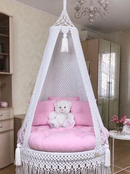 A perfect swing for a girl's room. This white swing with a pink mattress and a teddy bear is a dream come true for any child.