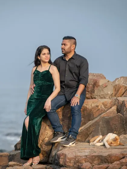 A relaxed pre-wedding portrait on the rocks, with a sleepy dog adding a touch of unexpected charm. It's these little details that make a photoshoot memorable.