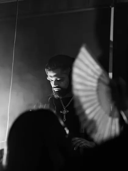 A moody black and white shot of me in a dark, smoky club. This captures the underground vibe of a true techno night.