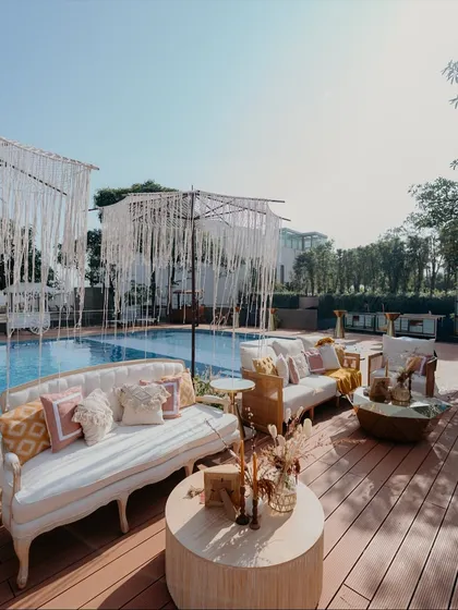 For a relaxed, boho-chic vibe by the pool, I used macrame umbrellas and elegant white sofas. This setup provided a comfortable and stylish lounge area for guests to enjoy the poolside Haldi festivities.
