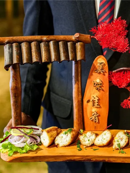 An example of our creative plating for starters. This dish is served on a wooden platter with a miniature Japanese Torii gate, transforming a simple appetizer into a work of art.