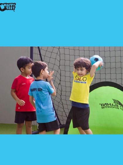 Learning to throw the ball is just as important as kicking it. This activity helps develop arm strength and coordination. You can see the focus as this little player prepares for a throw in.
