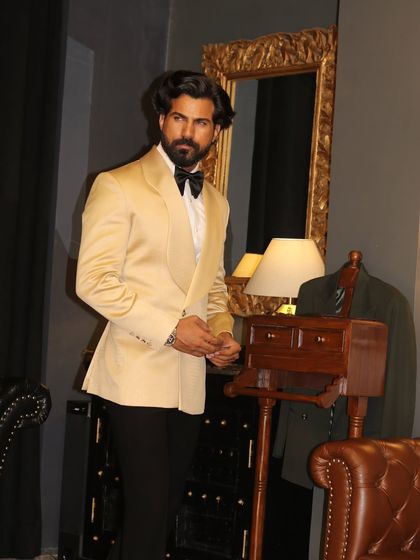 The clean lines of the ivory shawl lapel tuxedo are perfect for creating a sharp, memorable silhouette.