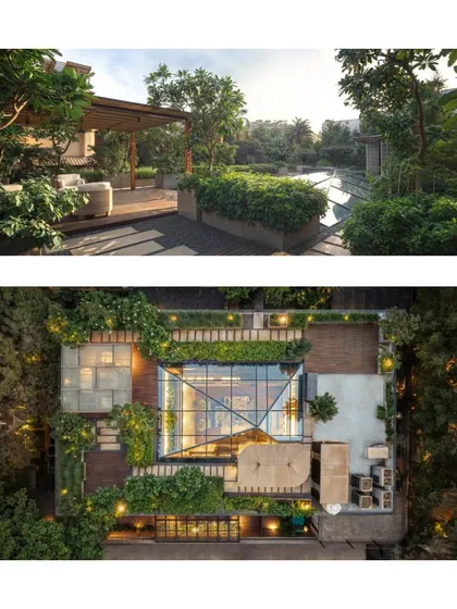 An aerial and side view of the retrofitted home, revealing a lush rooftop garden and multiple terraces that maximize green space on an urban plot.