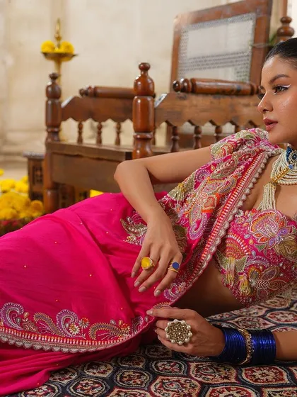 A vibrant pink saree with heavy paisley embroidery from the Jashn-de-Fleurs collection, a true celebration of colour and craft.
